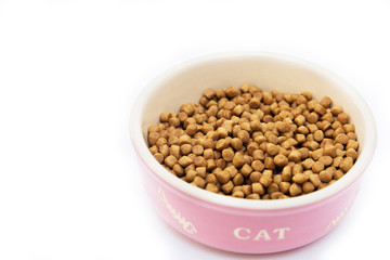 Pet food in the shape of balls in white bowl on white background. Isolated on white