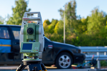 Surveyor equipment (theodolit or total positioning station) on the construction site of the motorway or road