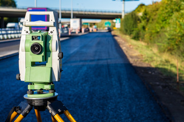 Surveyor equipment (theodolit or total positioning station) on the construction site of the...