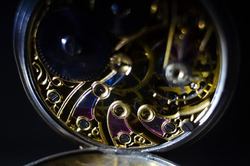 Fototapeta na wymiar Skeleton of vintage handmade pocket watches, winter time and summer time concept, selective focus.