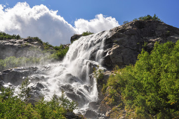 Waterfall scenes in mountains, national park Dombai, Caucasus, Russia, Europe. Sunshine weather and blue sky, summer day