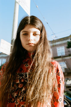 Portrait of brunette teenage girl standing outdoors