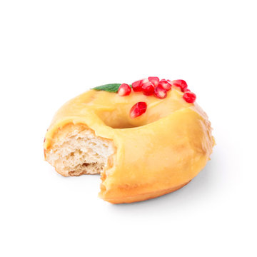 Donut glazed with honey and pomegranate. View from a forty-five degree angle. Isolated image. The side-bite donut.