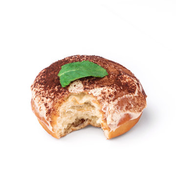Glazed donut with cream and chocolate powder. View from a forty-five degree angle. Isolated image. The side-bite donut.