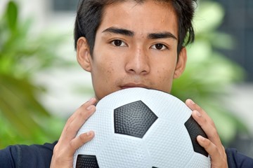 Unemotional Male Soccer Player With Soccer Ball