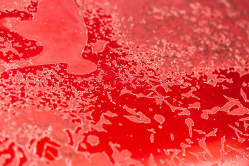 Old car cracked and peeling painted metal texture. Red rusty car background.