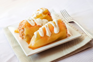 Stuffed pepper with meat and rice on a white square plate