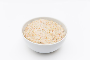 Oatmeal in white plate on white background. Isolated on white