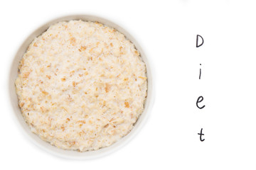Oatmeal in white bowl with inscription diet on white background. Isolated on white