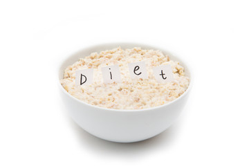 Oatmeal with inscription diet in white bowl on white background. Isolated on white. Healthy food