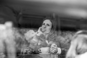 Young woman sitting alone in coffee shop