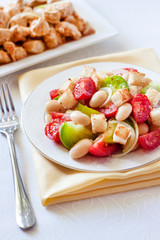 Salad with three kinds of tomatoes, boiled white kidney beans and croutons from white bread