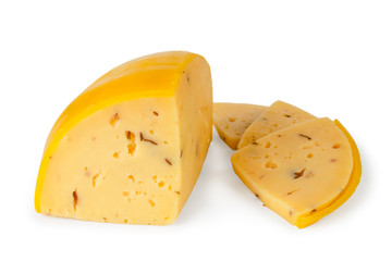 Cheese in wax shell cut into pieces on a white, isolated.