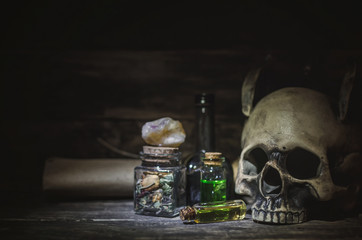 Magic potion and human skull on magic table background. Witchcraft concept.