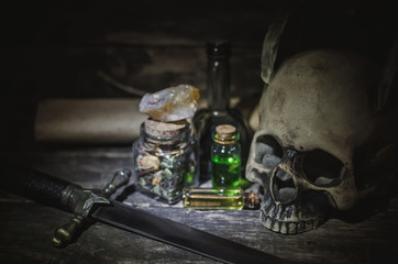 Magic potion and human skull on magic table background. Witchcraft concept.