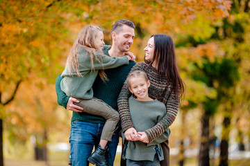 Portrait of happy family of four in autumn