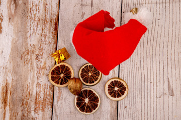 Santa hat with golden gift and fruit slices