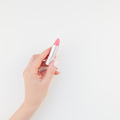 Woman hand with pink lipstick