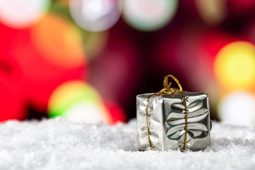 Christmas presents on the snow with a lights background