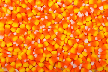 Background top view flat lay of candy corn.  Candy corn is a candy most often found in the United States and Canada, popular primarily around Halloween