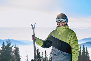 Portrait of a skier in the ski resort on the background of mountains and blue sky, Bukovel.  Ski...