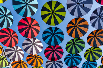 Colorful umbrellas background. Colorful umbrellas in the sunny sky. Street decoration.