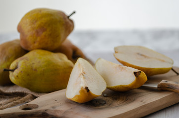 Naklejka na ściany i meble Fresh ripe organic yellow pears on rustic wooden table,