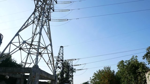 a high voltage power pylons against blue sky