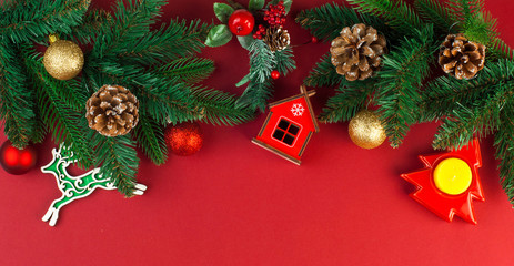 Fototapeta na wymiar Christmas card with Christmas tree decor on red background