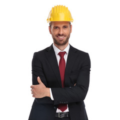 portrait of confident manager with yellow protection helmet standing