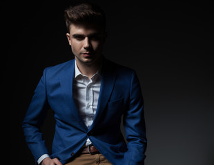 portrait of sexy smart casual man in blue suit