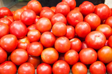 Fresh ripe tomatoes in a box for sale in the grocery shop