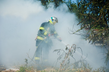 Firefighter extinguishes a fire