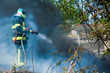 Firefighter extinguishes a fire