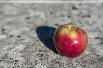 red-yellow green apple on a stone-based basis