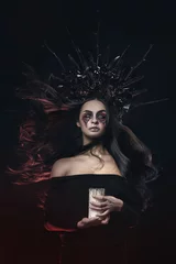 Fototapete Rund Terrible horror Halloween Vampire Woman portrait. Beauty Vampire Witch lady with blood on mouth posing in deep forest. Fashion Art design. holds a candle in his hands and reads curses © oes