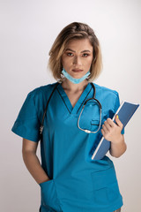 Portrait of young doctor with stethoscope holding paper results and standing straight with right hand in her pocket. Healthcare practicttioner specialist