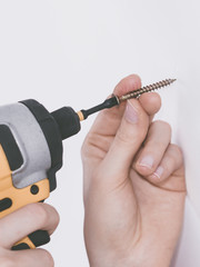 Person drilling in wall
