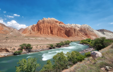 Fototapeta na wymiar Red Rocks along Kokemeren River near Kyzyl-Oi, Kyrgyzstan taken in August 2018