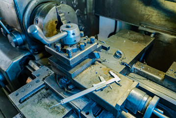 metal lathe processes metal parts on the production in the plant. The work process of the lathe. Close-up