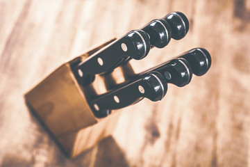 Macro Of A Kitchen Knive Block With 6 Knives On A Table, High Angle View