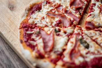 Delicious Italian pizza on a cutting board on dark background