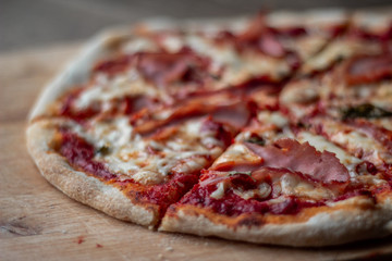 Delicious Italian pizza on a cutting board on dark background