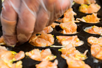 Close up baking prawns in baking pan with holes