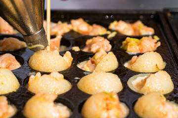Close up baking prawns in baking pan with holes