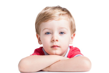 Portrait of adorable little boy looking to the camera, isolated on white background © cristovao31