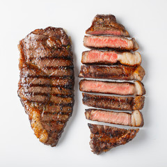 Two grilled marbled beef steaks striploin isolated on white background, top view