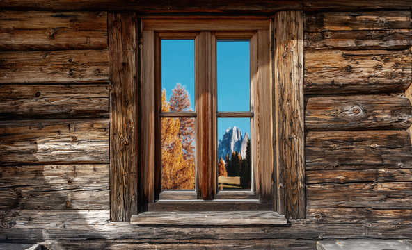 View on the mountain and forest from the window of a wooden house