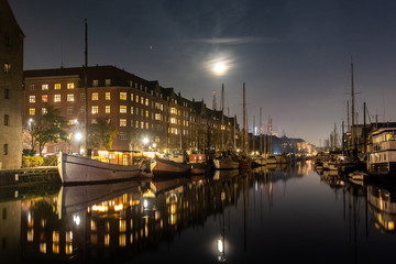 Fototapeta premium Cozy christianshavn channel in the danish capital of Copenhagen. This is the harbor for many liveaboard and boats made for housing