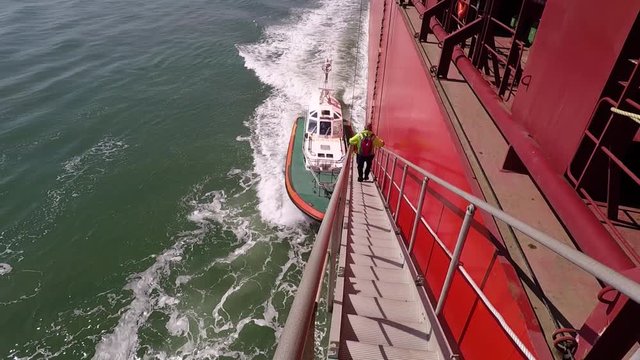 Pilot leaving a huge container vessel in Suez channel / pilot off